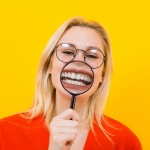 Blonde woman in dress with magnifying glass